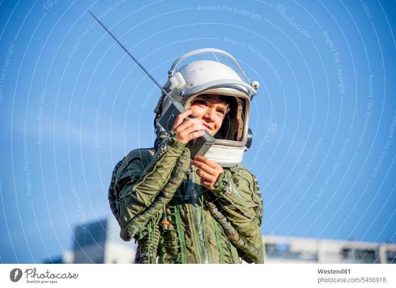 Boy wearing a space suit and using walkie talkie human human being human beings humans person persons caucasian appearance caucasian ethnicity european 1