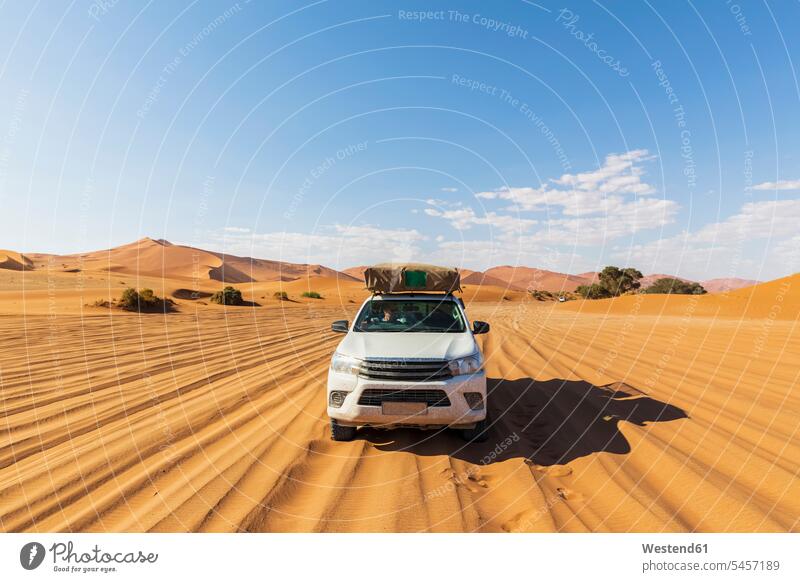 Africa, Namibia, Namib desert, Naukluft National Park, off-road vehicle on sand track on the move on the way on the go on the road National Parks Travel Deserts