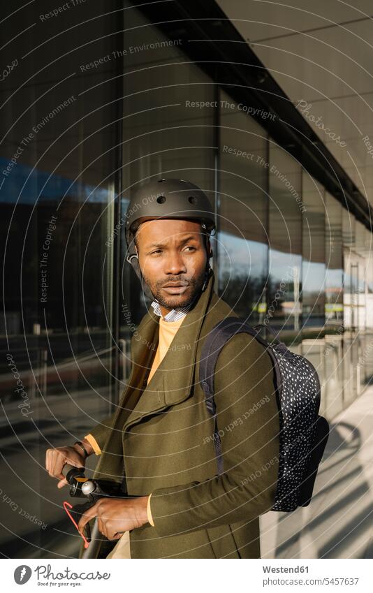 Portrait of stylish man with helmet and scooter in the city business life business world business person businesspeople Business man Business men Businessmen