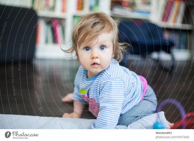 Girl sitting on floor Seated home at home childhood cute twee Cutie looking at camera looking to camera looking at the camera Eye Contact carefree baby girls