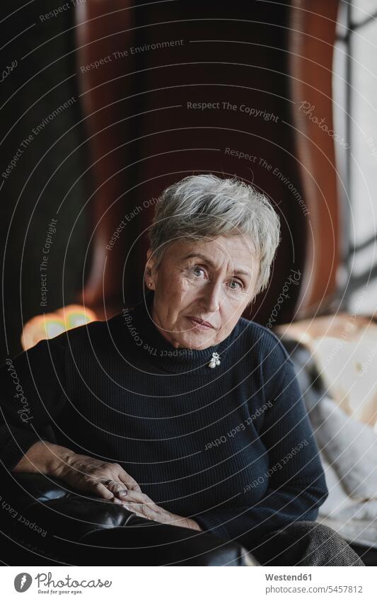 Portrait of senior woman sitting on couch females women settee sofa sofas couches settees Seated senior women elder women elder woman old portrait portraits