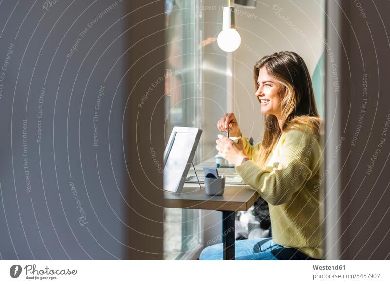 Smiling young woman in a cafe females women smiling smile Adults grown-ups grownups adult people persons human being humans human beings Joy enjoyment pleasure