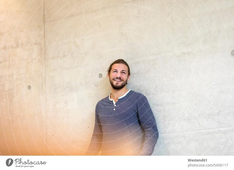 Portrait of smiling man leaning against wall walls smile portrait portraits men males Adults grown-ups grownups adult people persons human being humans