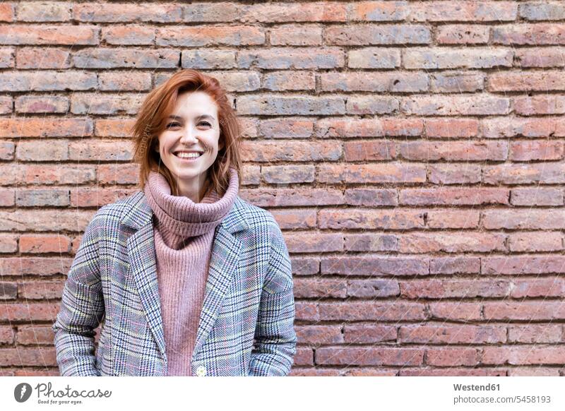 Portrait of smiling young woman standing wearing bra and pyjama