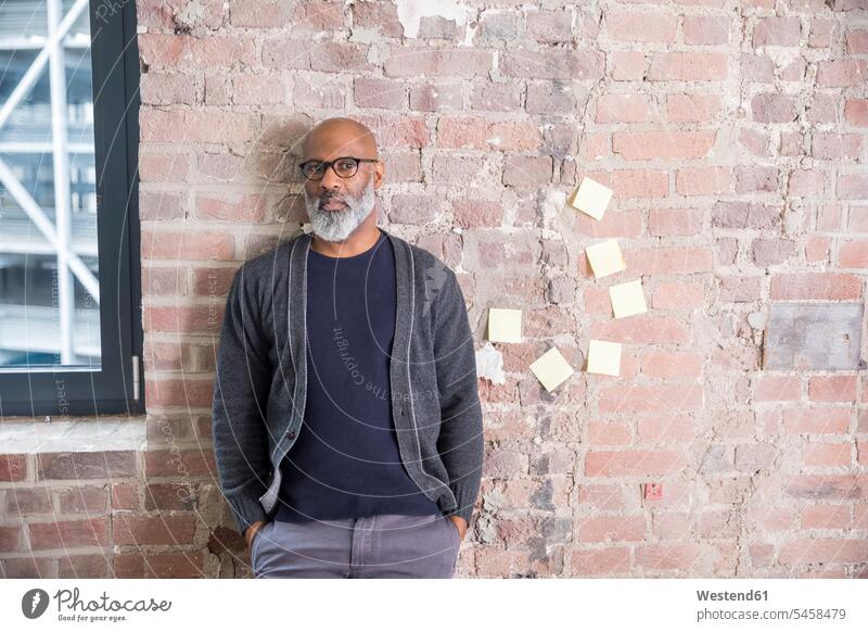 Portrait of freelancer leaning against wall in a loft lofts walls freelancing portrait portraits businesswear business attire business clothing