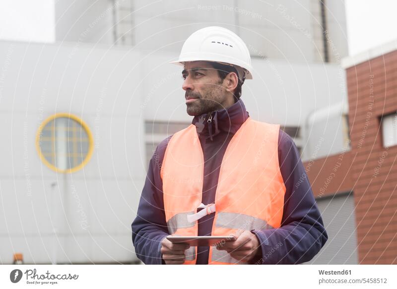 Man wearing reflective vest and hard hat holding tablet looking around digitizer Tablet Computer Tablet PC Tablet Computers iPad Digital Tablet digital tablets