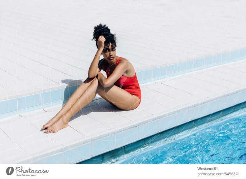 Young woman stretching in swimming pool - a Royalty Free Stock