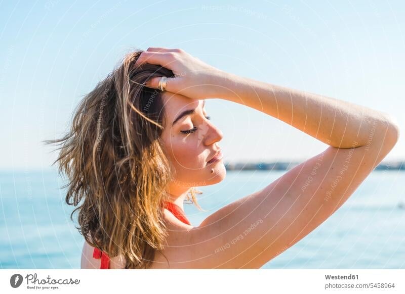 Portrait of attractive young woman on the beach females women beautiful pretty good-looking Attractiveness Handsome portrait portraits beaches Adults grown-ups