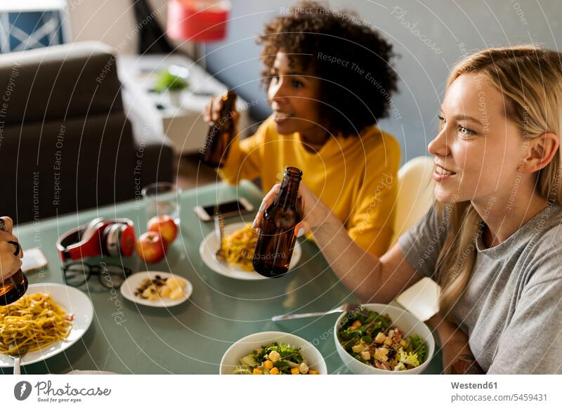 Girlfriends sitting at table eating and drinking beer Beer Beers Ale Table Tables girlfriend girl friend girl friends Seated Alcohol alcoholic beverage