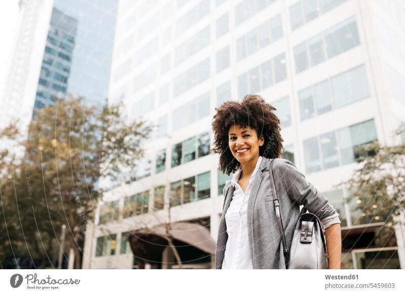 Portrait of smiling woman with bag outdoors females women portrait portraits bags Adults grown-ups grownups adult people persons human being humans human beings