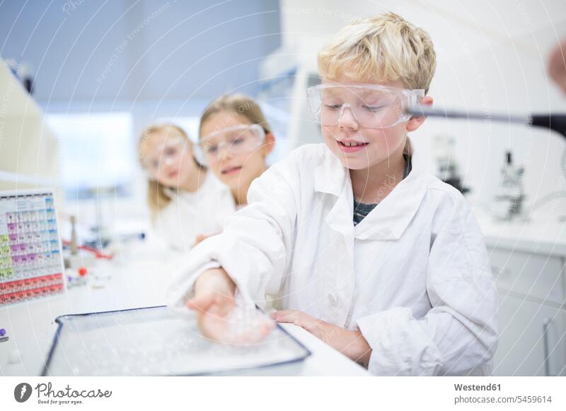 Pupils in science class experimenting school schools classmates student pupils effort attempt schoolchildren education trying testing sampling inquisitive