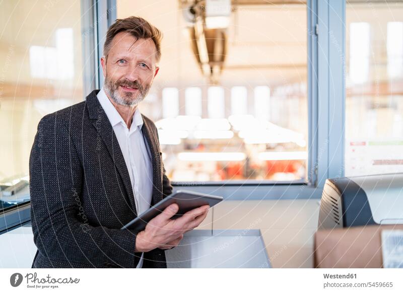 Portrait of businessman using tablet at the window with factory background digitizer Tablet Computer Tablet PC Tablet Computers iPad Digital Tablet