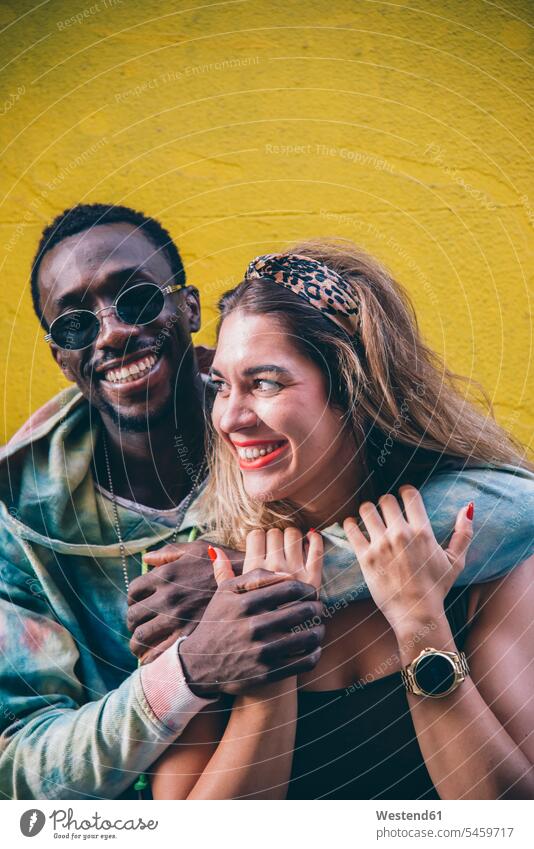 Portrait of happy couple in front of yellow wall human human being human beings humans person persons African black black ethnicity coloured