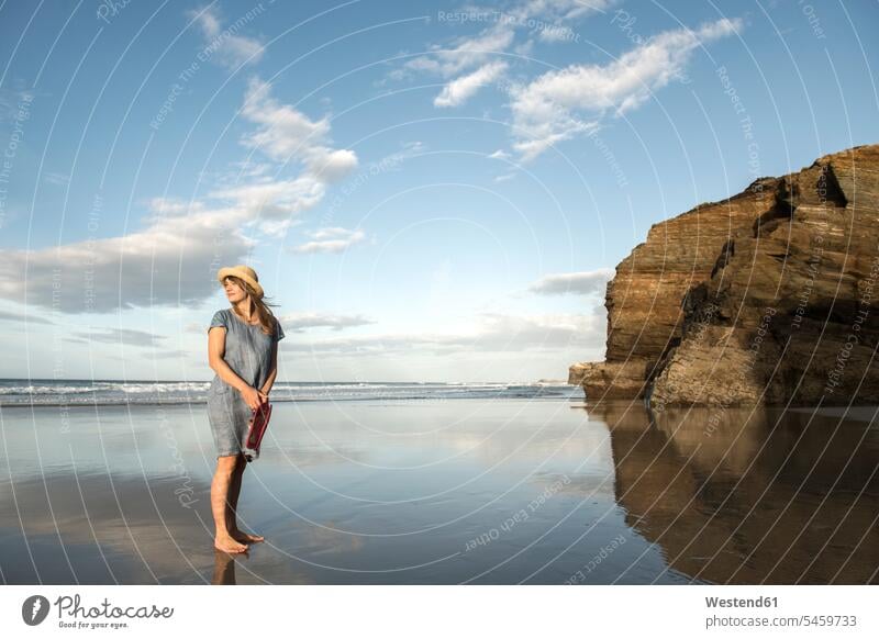 Woman standing on beach, looking at sea human human being human beings humans person persons caucasian appearance caucasian ethnicity european 1 one person only