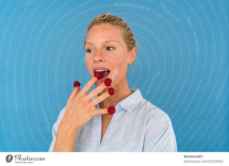 Portrait of blond woman with raspberries on his fingers human human being human beings humans person persons caucasian appearance caucasian ethnicity european 1