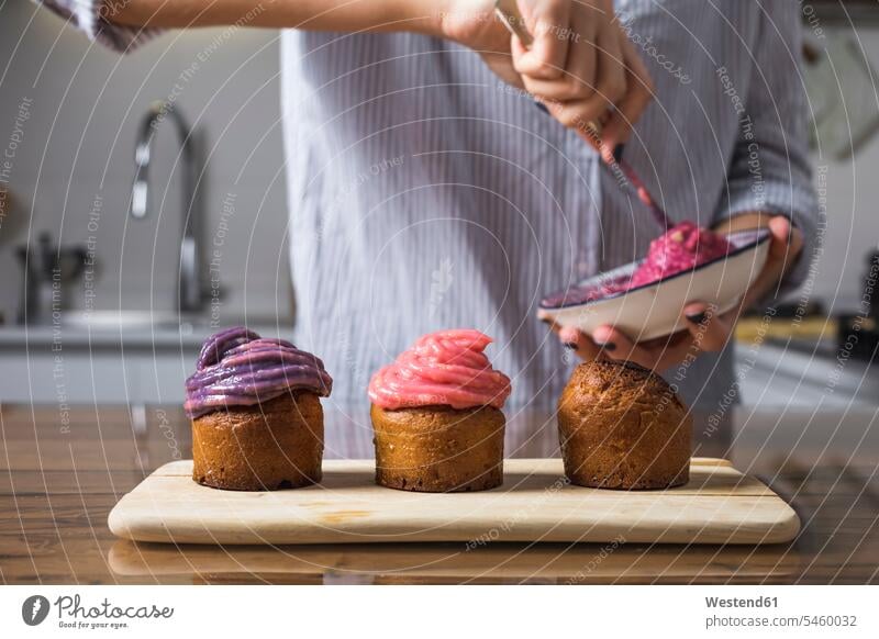 Woman preparing muffins at home Food Preparation preparing food cup cake Cup cakes Cupcakes cupcake cream creams cosmetic cream baking bake preparation prepare