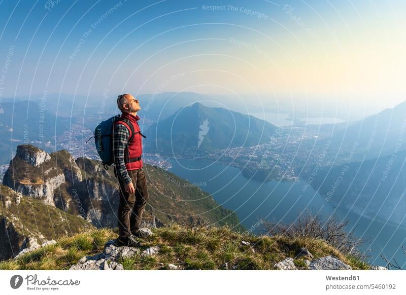 Rear view of hiker on mountaintop, Orobie Alps, Lecco, Italy human human being human beings humans person persons caucasian appearance caucasian ethnicity