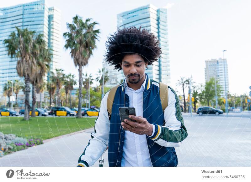 Casual businessman with bicycle using cell phone in the city, Barcelona, Spain business life business world business person businesspeople Business man