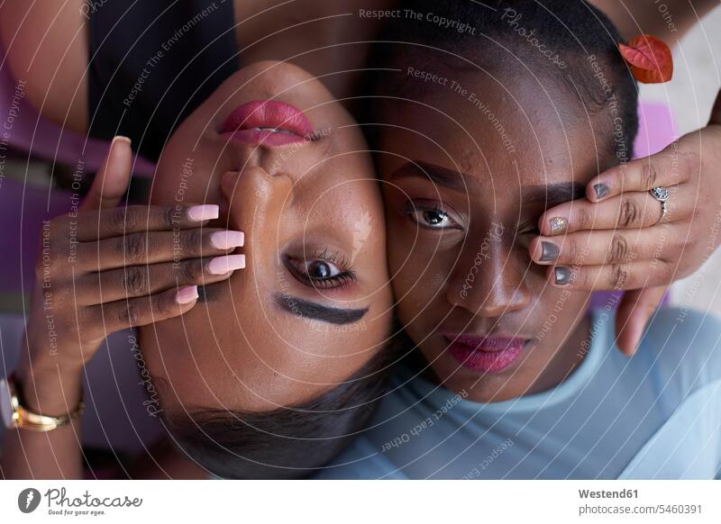 Portrait of two young women head to head covering eyes with hands human human being human beings humans person persons African black black ethnicity coloured 2