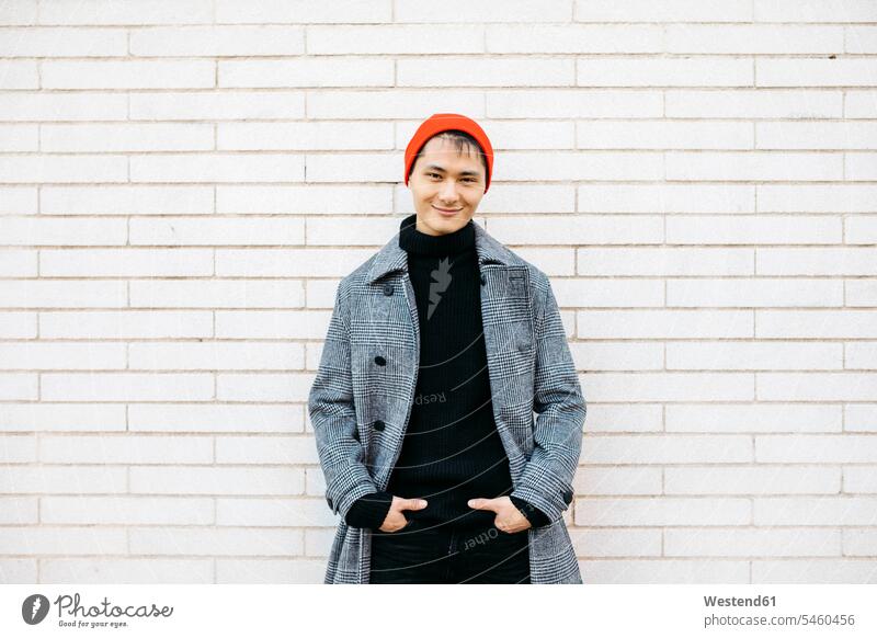 Portrait of stylish young man wearing cap, black turtleneck pullover and grey coat wall walls men males gray Coat Coats Adults grown-ups grownups adult people