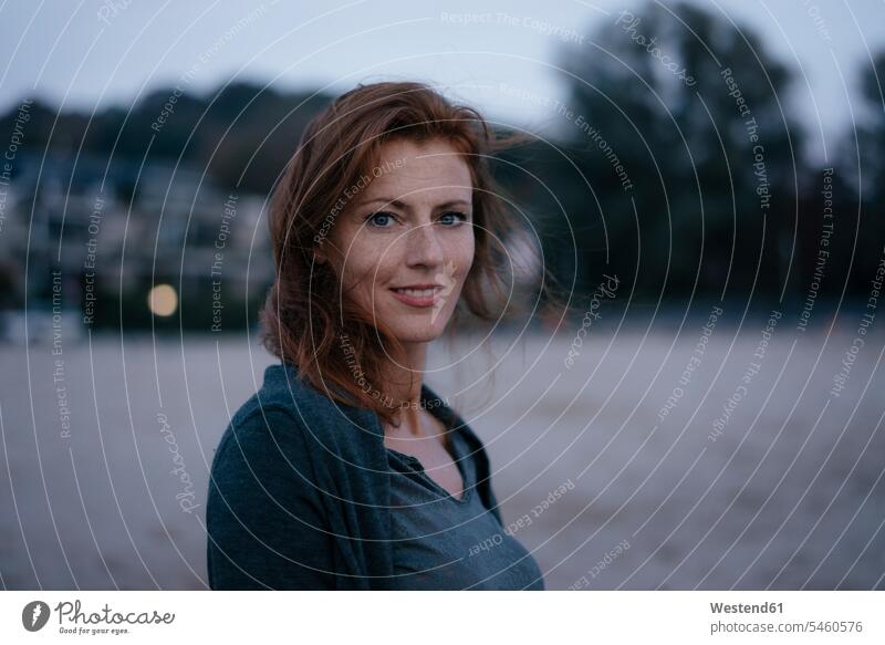 Germany, Hamburg, portrait of smiling redheaded woman red hair red hairs red-haired smile portraits females women happiness happy people persons human being