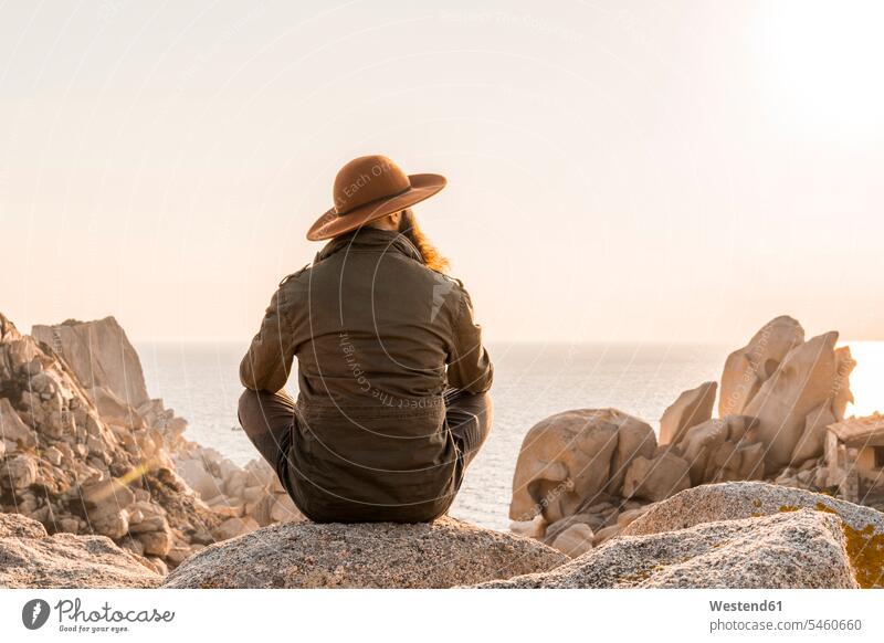 Italy, Sardinia, back view of man wearing hat looking at view - a Royalty  Free Stock Photo from Photocase