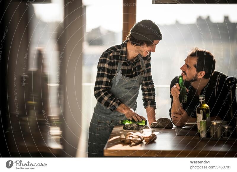 Friends cooking an d drinking beer in the kitchen together preparing Food Preparation preparing food dough Beer Beers Ale friends rolling flat flattening