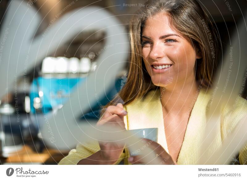 Portrait of smiling young woman in a cafe portrait portraits females women smile Adults grown-ups grownups adult people persons human being humans human beings