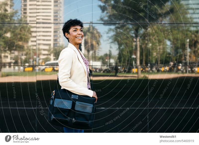 Woman with laptop bag walking human human being human beings humans person persons Mixed Race mixed race ethnicity mixed-race Person 1 one person only