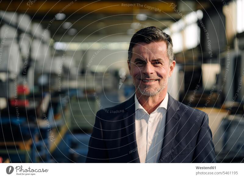 Portrait of a smiling businessman in a factory human human being human beings humans person persons caucasian appearance caucasian ethnicity european 1