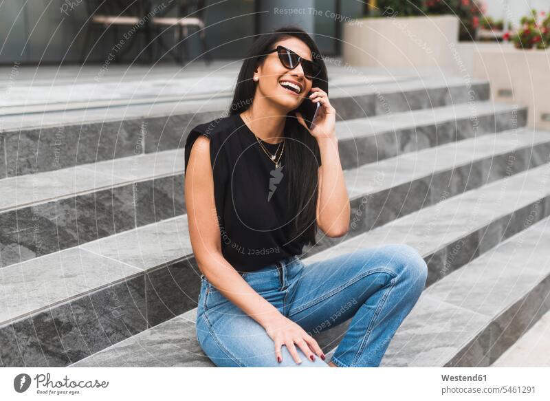 Woman with sunglasses using smartphone in city human human being human beings humans person persons 1 one person only only one person adult grown-up grown-ups