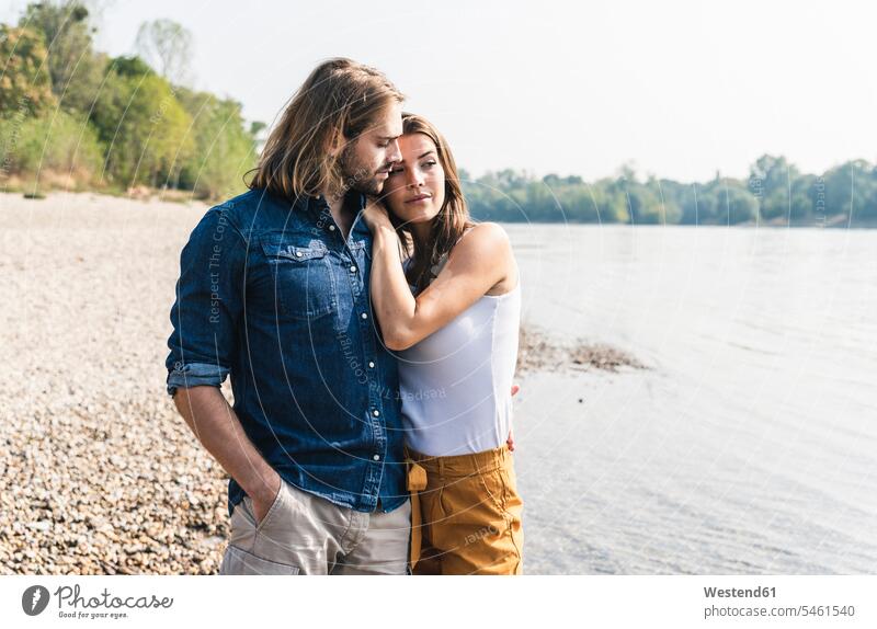 Young couple in love at the riverside River Rivers twosomes partnership couples riverbank water waters body of water people persons human being humans