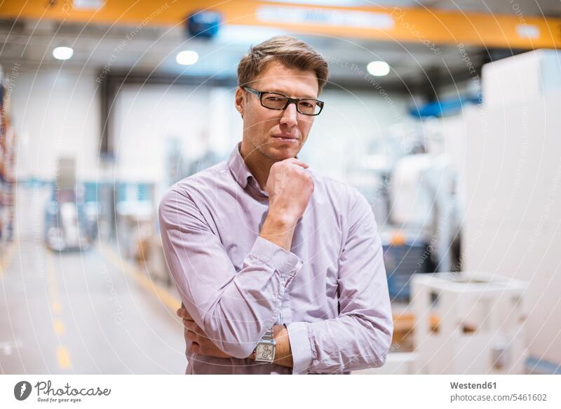 Portrait of serious businessman in factory factories portrait portraits earnest Seriousness austere Businessman Business man Businessmen Business men