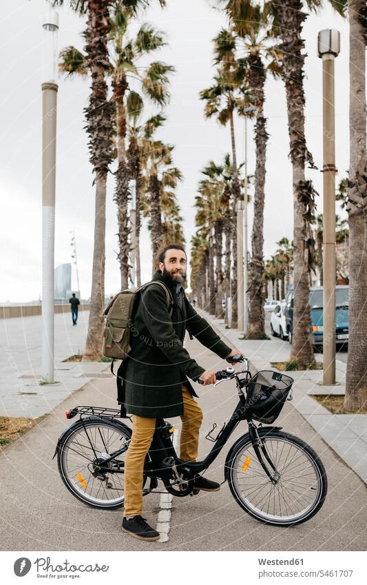 Portrait of man with e-bike on a promenade E-Bike Electric bicycle Electric Bike bikes bicycles males portrait portraits promenades transportation Adults