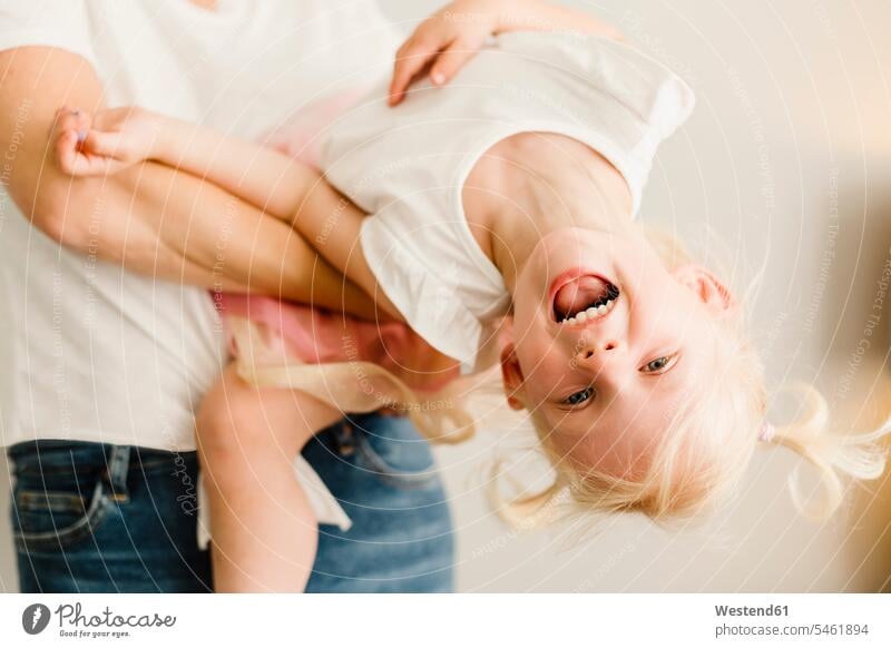 Portrait of happy little girl playing with her mother females girls mommy mothers mummy mama happiness portrait portraits child children kid kids people persons