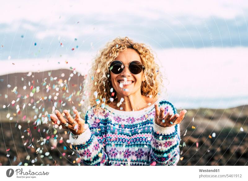 Portrait of happy blond woman celebrating with confetti, Tenerife, Spain balloons relax relaxing celebrate partying Ardor Ardour enthusiasm enthusiastic excited