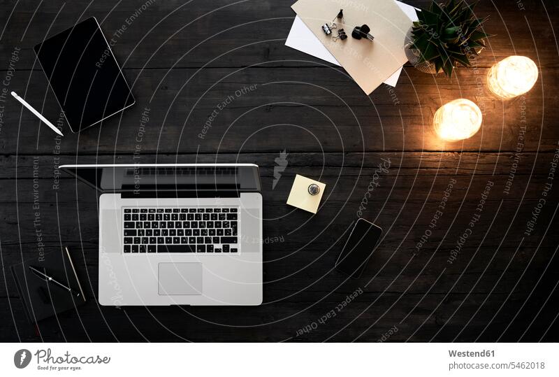 Mobile devices on desk with pen and lamps wireless Wireless Connection Wireless Technology Wireless Communication black background black backgrounds concept