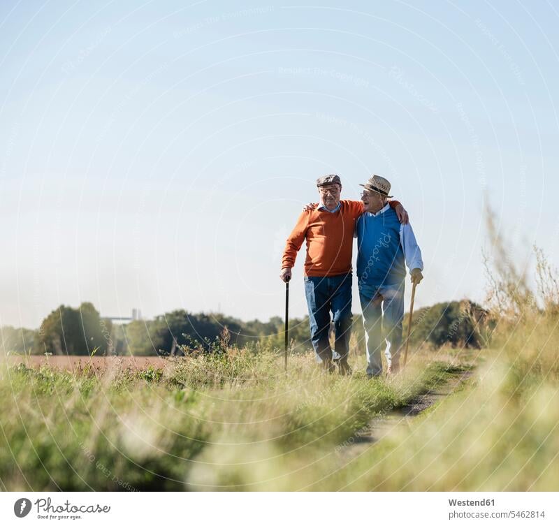 Two old friends taking a stroll through the fields, talking about old times arm around arms around Best Friend Best Friends Best Pal walking going Field Fields