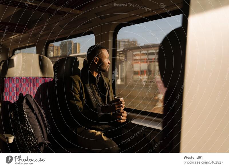 Stylish man with reusable cup inside a train business life business world business person businesspeople Business man Business men Businessmen human human being