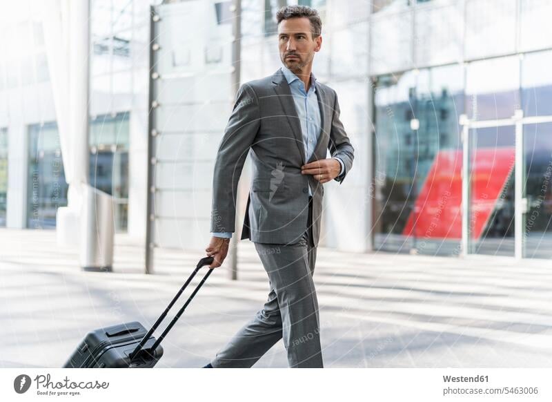 Businessman with baggage on the go human human being human beings humans person persons caucasian appearance caucasian ethnicity european 1 one person only