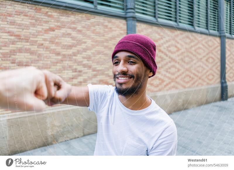 Portrait of smiling man bumping fist T- Shirt t-shirts tee-shirt smile relax relaxing relaxation delight enjoyment Pleasant pleasure Contented Emotion pleased