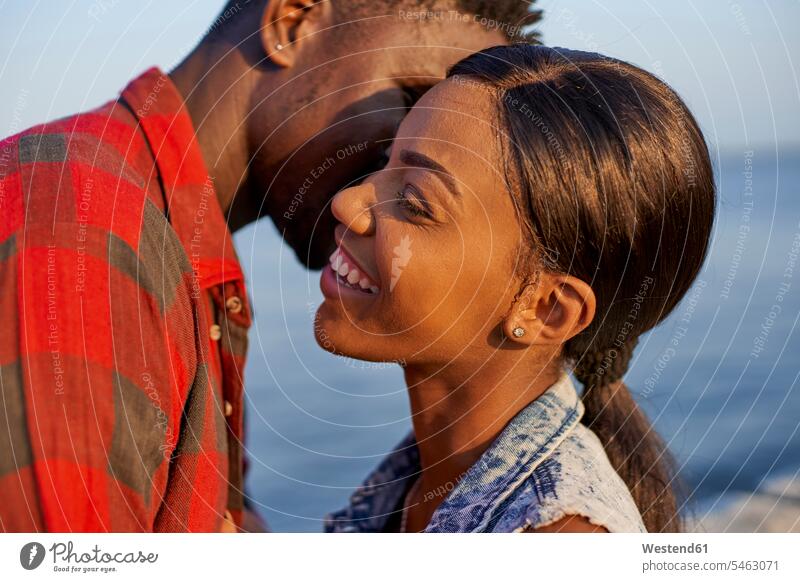 Romantic couple standing at the sea, portrait human human being human beings humans person persons African black black ethnicity coloured 2 2 people 2 persons