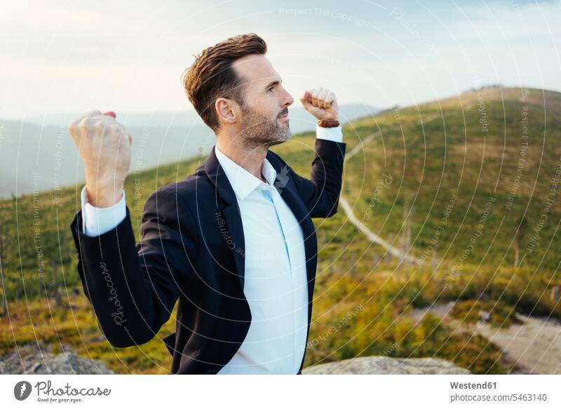 Self-confident businessman standing on top of a mountain mountains Self-confidence self-confident poised Self-Assured Self-Assurance Businessman Business man