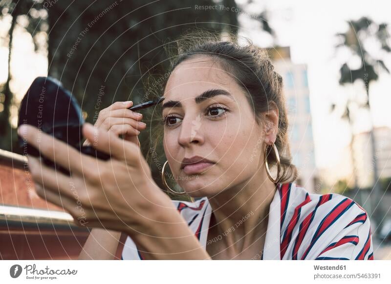 Portrait of woman applying mascara females women Adults grown-ups grownups adult people persons human being humans human beings beautiful hand mirror