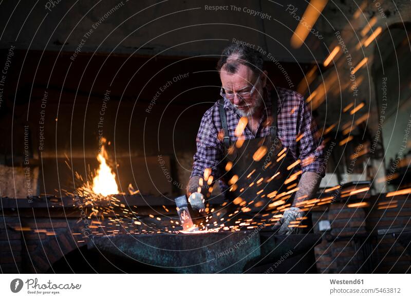 Blacksmith Working With Hammer At Anvil In His Workshop A Royalty Free Stock Photo From Photocase