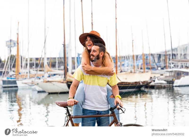 Spain, Barcelona, happy couple with bicycle at the seaside coast coastline coast area Seacoast bikes bicycles twosomes partnership couples happiness Fun