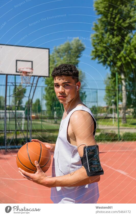 Young man playing basketball, smartphone in arm pocket one young man only 1 only one young man one young  man mobile phone case cell phone case Motivation