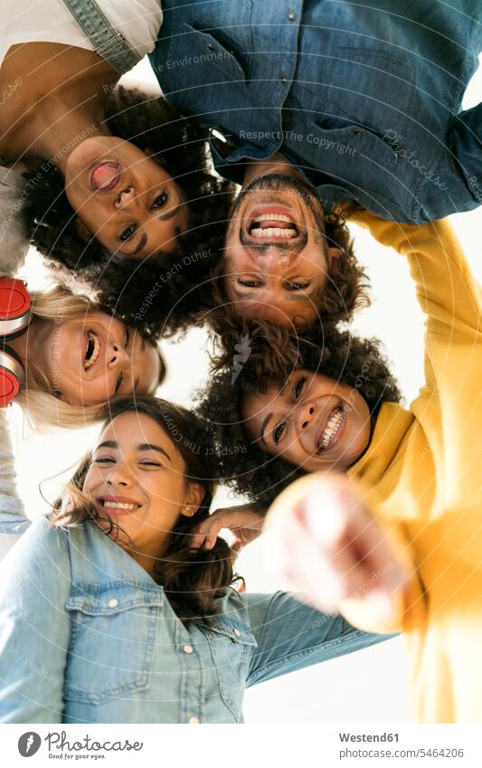 Group portrait of cheerful friends huddling portraits gaiety Joyous glad Cheerfulness exhilaration merry gay friendship enjoyment pleasure Pleasant delight