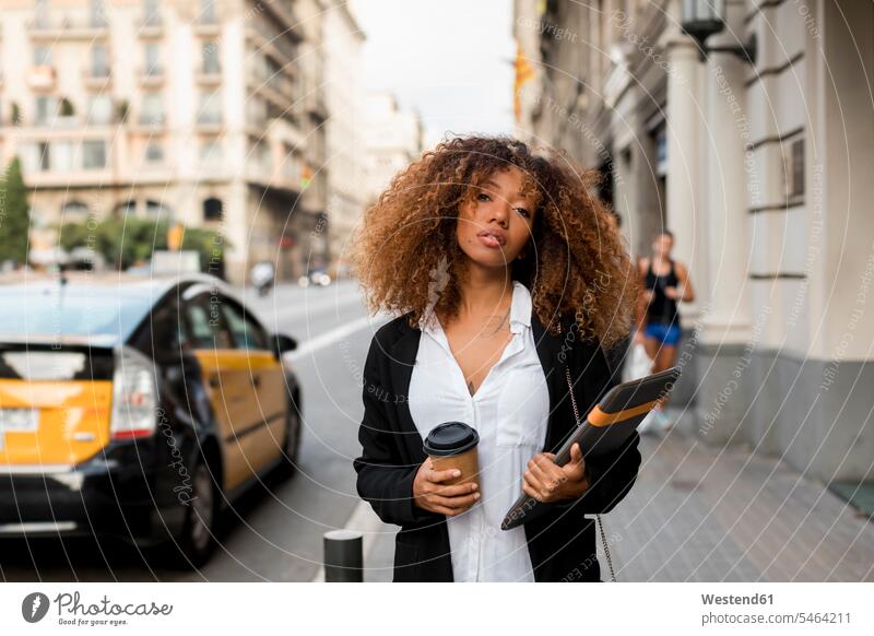 Young woman with laptop bag and coffee to go in the city, missing the taxi road streets roads laptop case females women Coffee to Go takeaway coffee