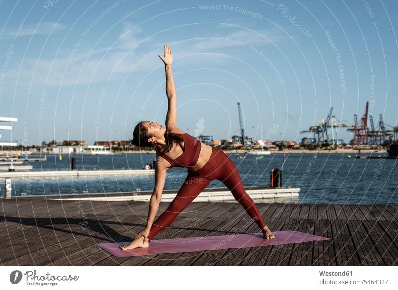 Asian Chinese Woman in Various Yoga Poses at the Beach Stock Image